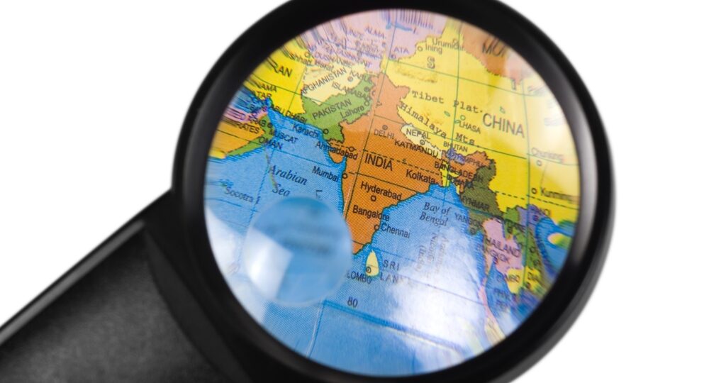 India on globe viewed through a magnifying glass
