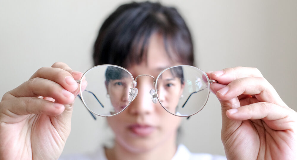 Short sighted,Woman,Is,Holding,Glasses,In,Hand,With,White,Background.