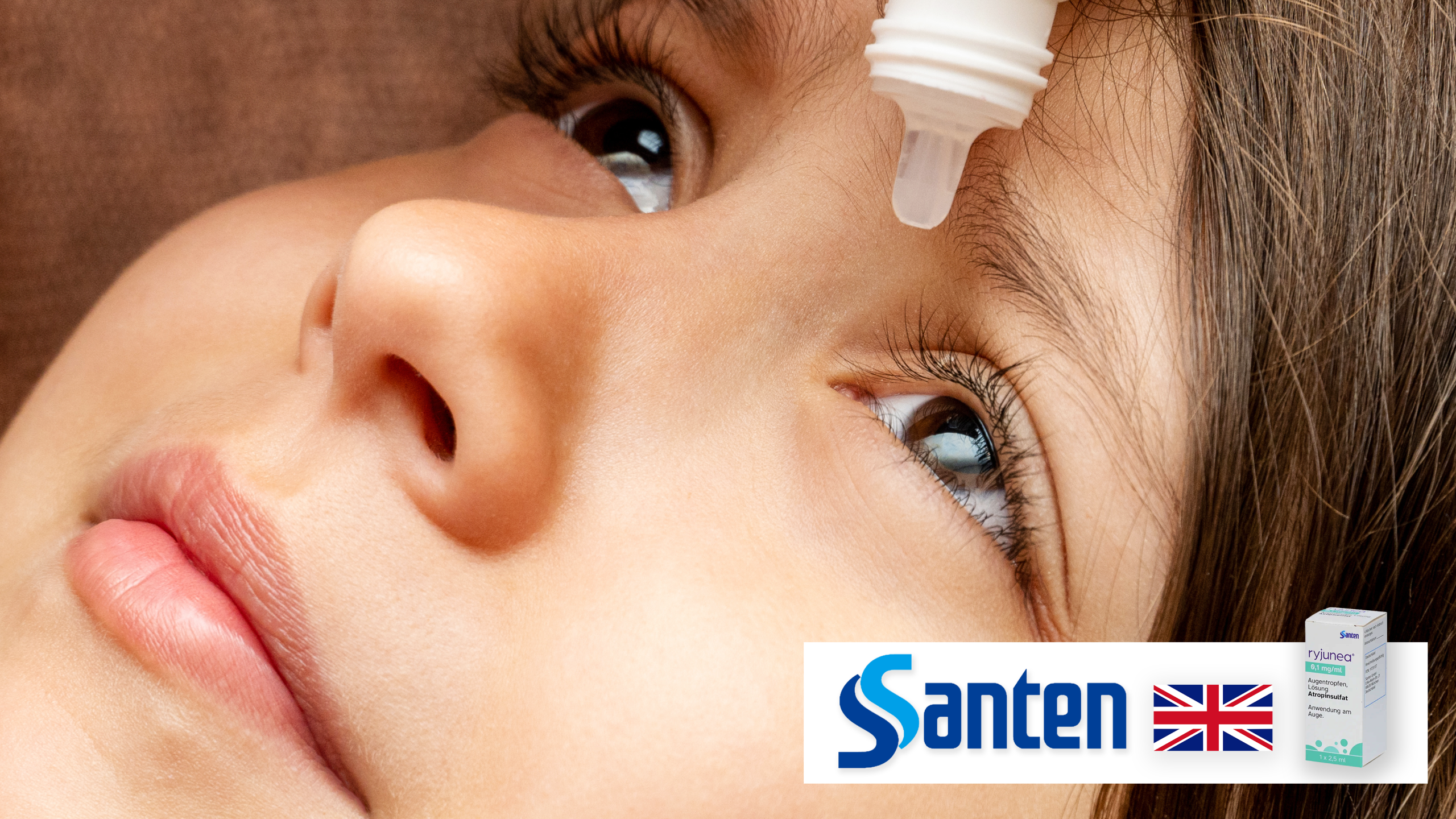 An image of a little girl having an eye drop and a logo of Santen, flag of UK, and a picture of Ryjunea